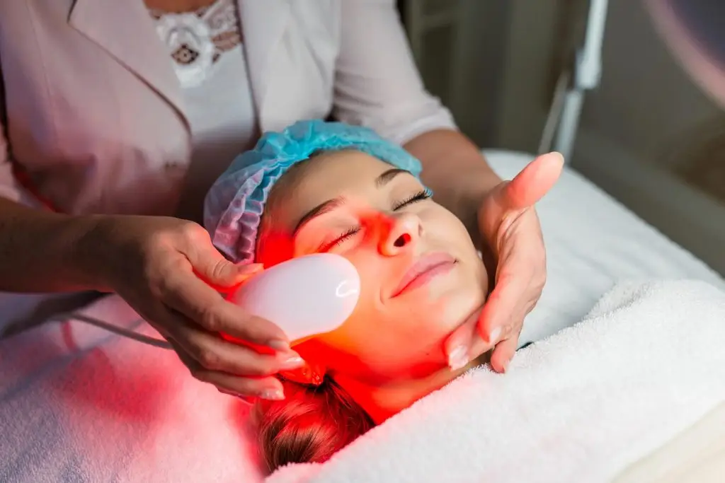 woman having a laser skin treatment procedure done in a skincare clinic
