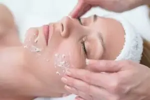 woman receiving professional facial exfoliation treatment